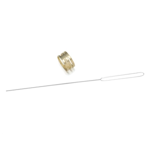 Detailed view of golden metal ring jewelry accessory and silver wire tool for DIY beading