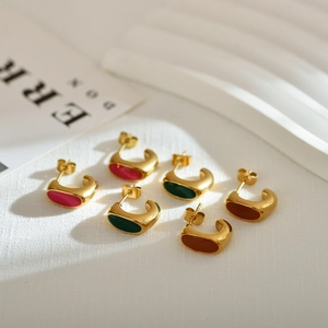 Three pairs of C-shaped geometric enamel earrings in rose, green, and orange finishes