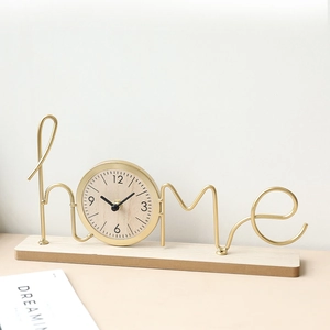 Minimalist gold iron home shaped desk clock with a natural wood base for home decor