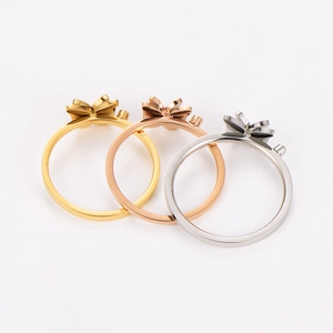 Detailed view of butterfly rings in gold, rose gold, and silver stainless steel finishes