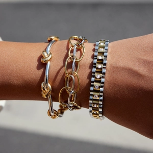 Three-piece stack of gold and silver stainless steel knot and zircon chain bracelets