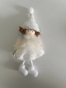 Close-up of white plush Christmas angel doll with silver wings and pointed hat decor