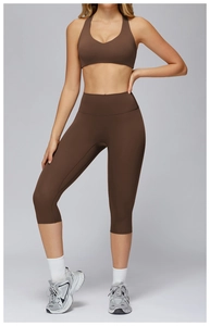 Close-up of high-waisted brown yoga leggings and matching sports bra set for fitness