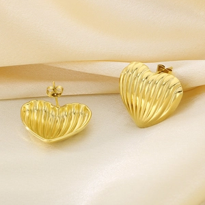 18K gold plated heart stud earrings with vertical stripe texture on silk background