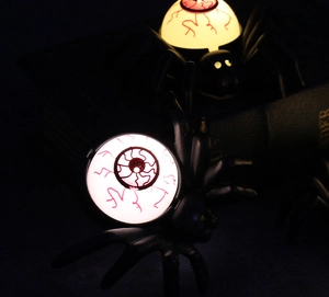 Detail of Halloween spider candle light with glowing bloodshot eyeball led decoration