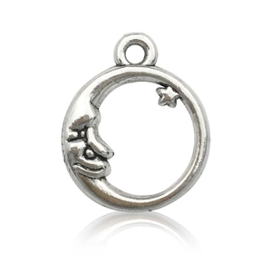 Macro shot of silver crescent moon and star pendant with polished metallic finish
