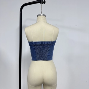 Détail d'un haut bustier en jean bleu montrant le design élastique froncé au dos