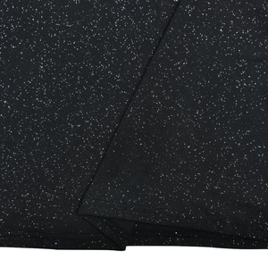 Close-up of black sequined fabric with shimmer texture and hem stitching detail