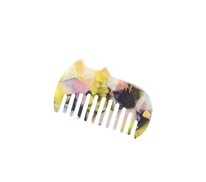 Detailed macro view of cat-shaped acetate hair comb with colorful marble texture pattern