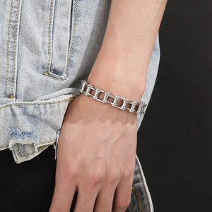 Close-up of men's 11mm silver bicycle chain style bracelet worn with denim jacket