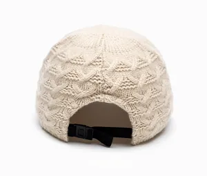 Detail of cable knit beanie back with adjustable black strap buckle for women