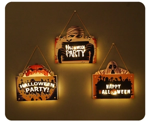 Close-up of lighted Halloween door signs with LED pumpkin, ghost and mummy motifs