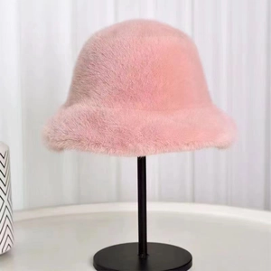 Detailed close-up of a pink plush faux fur bucket hat on a professional black stand