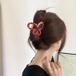 Elegant red butterfly hair claw clip for women shown on model for a stylish look