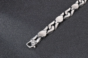 Detail of vintage geometric titanium steel chain bracelet featuring brushed metal finish