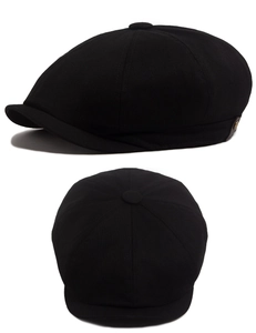 Detail view of black cotton newsboy cap with metal buckle and top button accents