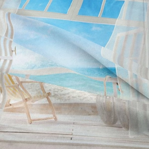 Close-up of the textured bohemian tapestry showing beach landscape print and soft fabric