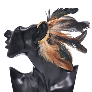 Detail of vintage peacock feather ear cuff wrap with gold metal hooks and real feathers