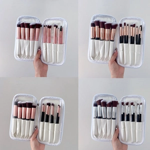 Macro shot of four marble makeup brush sets with portable white travel pouches