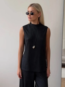 Detailed texture of high-quality black knitted sleeveless top and wide-leg trousers set