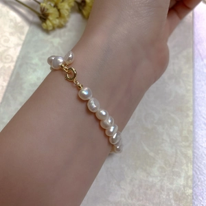 Close-up of irregular white baroque pearl bracelet with gold-filled spring clasp