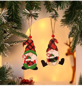 Close-up of wooden Christmas gnome pendants with red plaid hats and candy canes