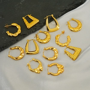 Fashionable gold stainless steel earring set with twisted hoop and bow designs on dark stone