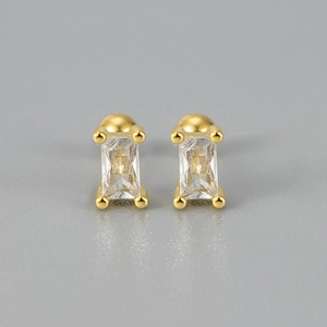 Close-up of gold screw stud earrings featuring rectangular clear crystals in a 4-prong setting