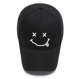 Classic black cotton baseball cap featuring white embroidered X-eye smile face design