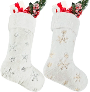 Detail of plush Christmas stockings featuring gold and silver sequin snowflake patterns