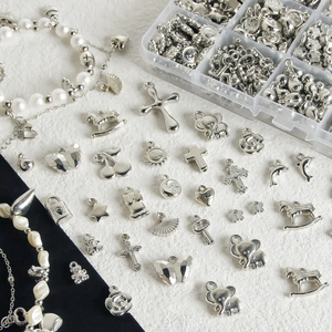 Y2K silver pendant collection with beads and charms in a transparent storage box