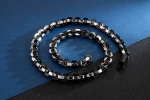 Detailed view of hip hop stainless steel necklace with silver and black hexagonal chain links
