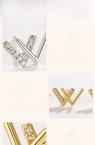 Detailed macro view of W-shaped earrings in gold and silver finish with inlaid zircons