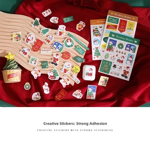 Detailed close-up of festive Christmas stickers with Santa and reindeer on wooden background