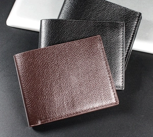 Close-up of classic bi-fold men's wallets in black and dark brown litchi grain PU leather