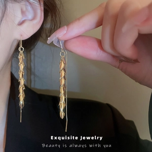 Elegant gold leaf tassel drop earrings for women with layered metallic wheat ear design