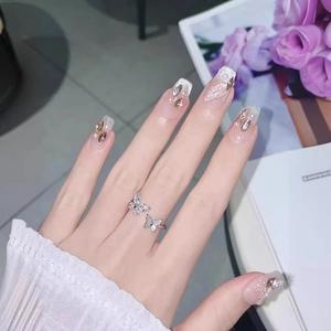 Handmade ice nude press-on nails with French tips, silver glitter and butterfly ring