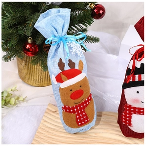 Close-up of blue reindeer Christmas wine bottle gift bags with linen texture and festive decor