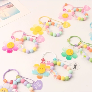 Macro shot of colorful acrylic sunflower keychain with love heart and alphabet beads