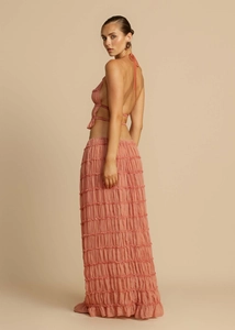 Detail of coral pink halter top and layered pleated maxi skirt set for women
