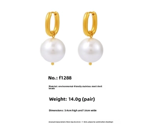 Detailed view of U-shaped gold earrings with large shell pearls and steel dimensions