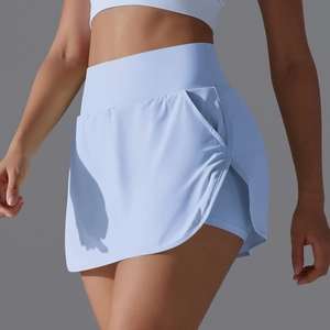 Close-up of high-waisted light blue tennis skort with side pocket and inner shorts
