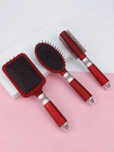 Detail view of 3-piece metallic red hairbrush set with ergonomic handles and massage bristles