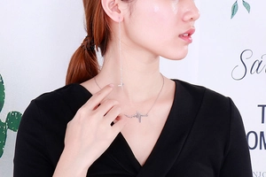 Close-up of minimalist heartbeat lightning necklace and long drop earrings set on model