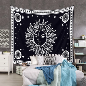 Detail of bohemian sun and moon tapestry on bedroom wall with celestial astrology design