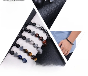 Detail view of natural gemstone beaded bracelets with metallic cross charms for men