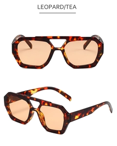 Detail view of irregular leopard print sunglasses with double bridge and tea lenses
