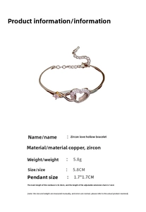 Detailed view of silver heart bangle with cubic zirconia inlay and square stone accent