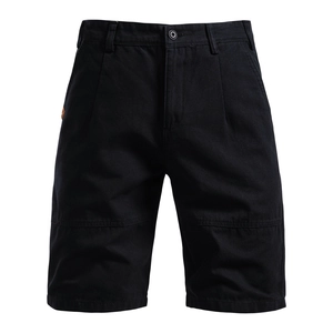 Detail of black cotton cargo shorts showing high-density fabric and metal button closure