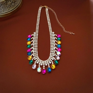 Detailed close-up of luxury geometric necklace with colorful crystals and fringe design